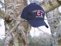 Cox Excalibur Red Brangus cap on a tree limb